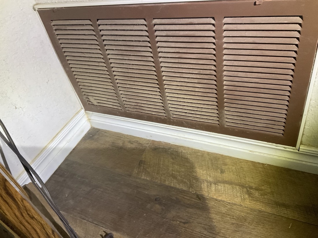 Clean rectangular return air grill installed in ceiling
