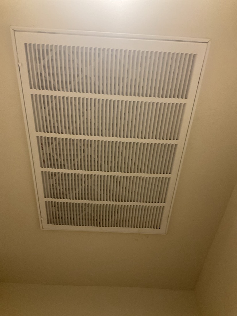 New pleated furnace filter in ceiling return air vent