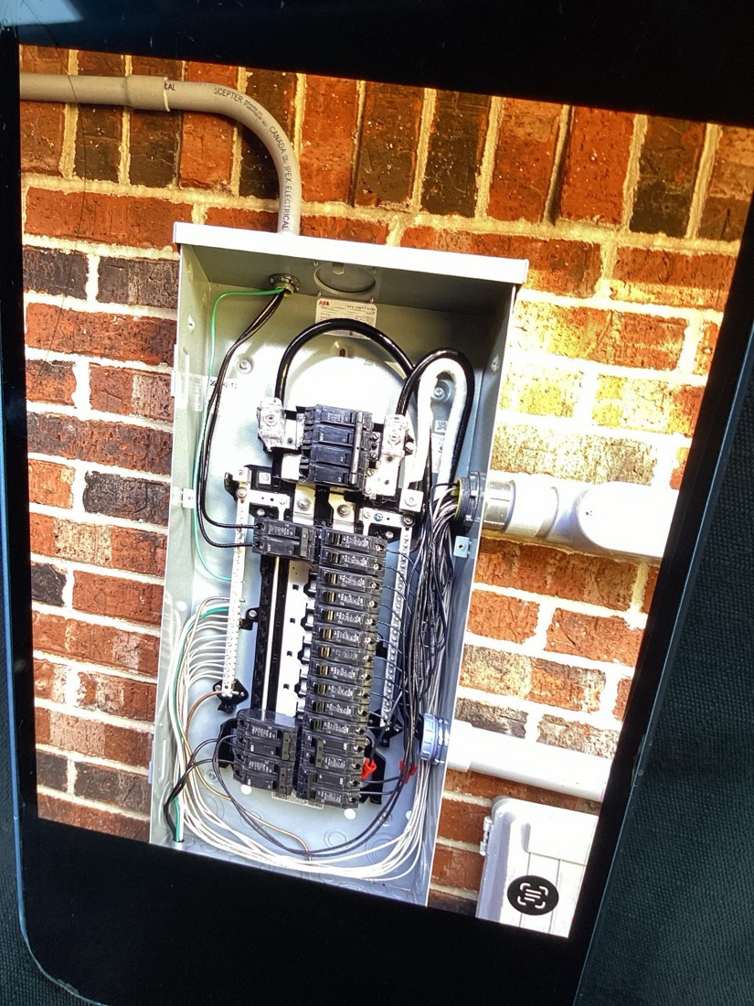 New electrical panel installation on brick exterior wall