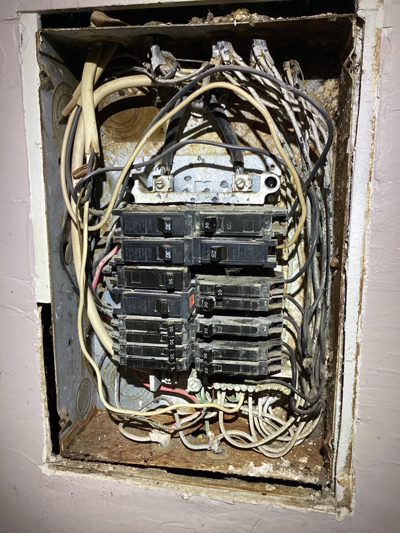 New electrical service panel with breakers and organized wiring.