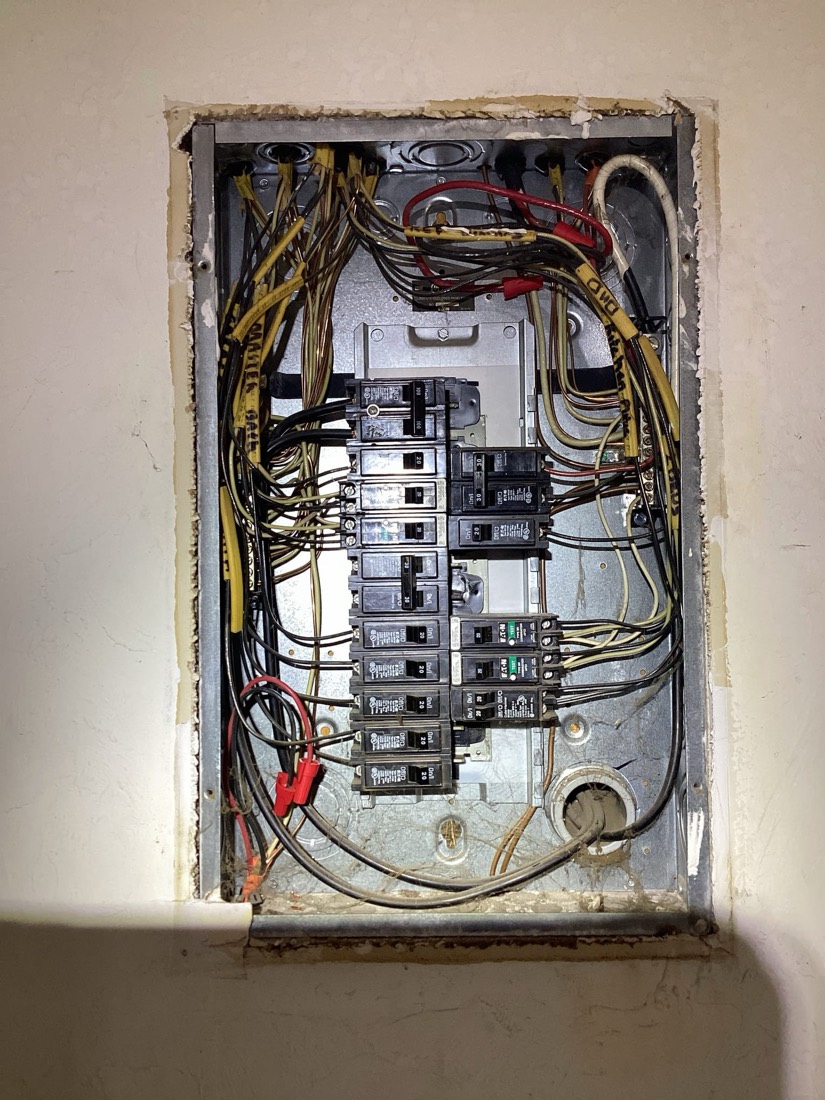 Electrical service panel with red and yellow wiring neatly organized