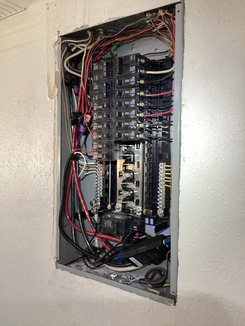 Installed electrical panel with neatly organized wiring and circuit breakers