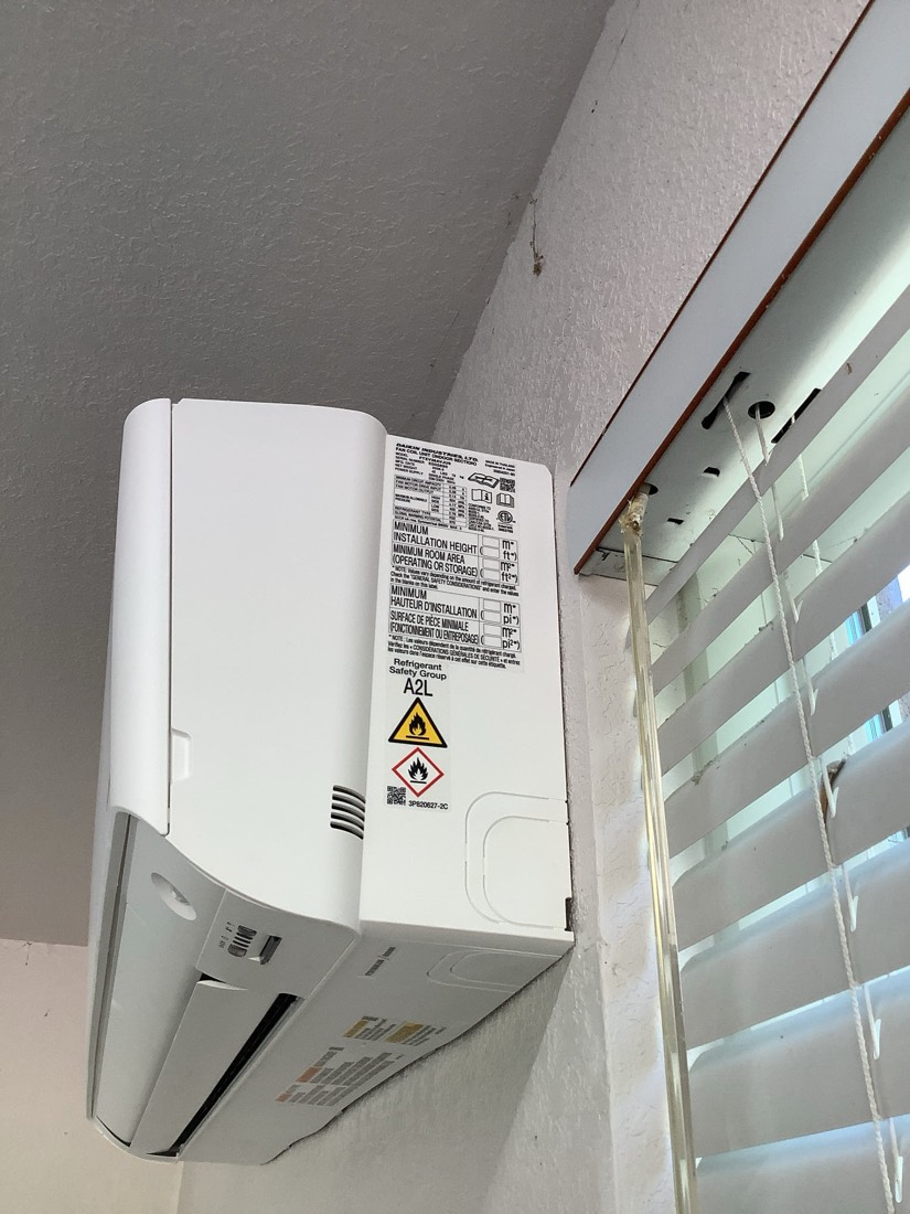 New mini-split indoor HVAC unit mounted on wall.
