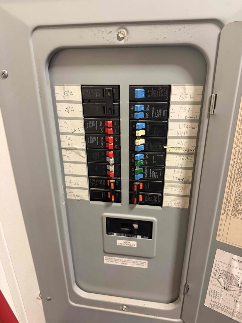 Electrical breaker panel with labeled switches and circuits.